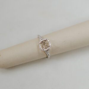 14kt White gold split band style halo engagement ring with .25ctw of accent round Diamonds.