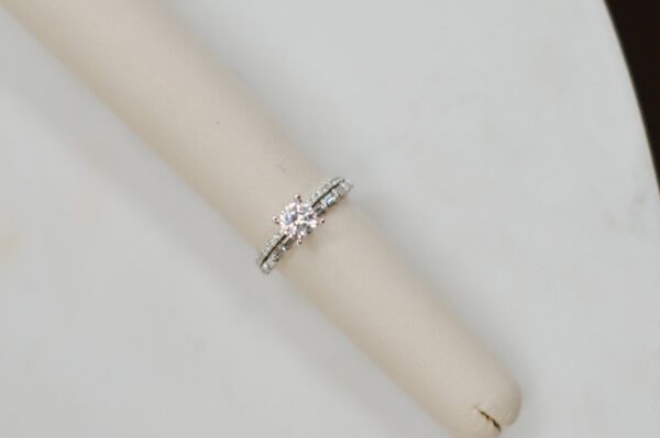 14kt White gold double band engagement ring with .37ctw of accent baguette and round Diamonds.