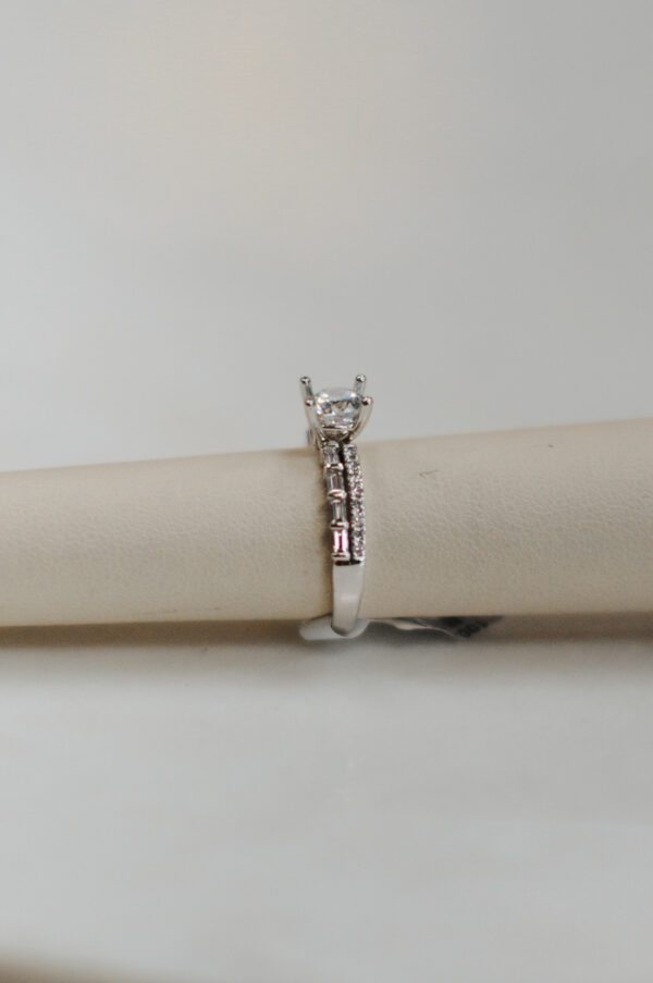 14kt White gold double band engagement ring with .37ctw of accent baguette and round Diamonds.
